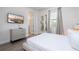 Bedroom featuring a queen bed, dresser, TV, and a view to the window at 7600 Mackinaw Ln, Kissimmee, FL 34747