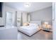 Modern bedroom featuring a queen bed, dresser, and mirror at 7600 Mackinaw Ln, Kissimmee, FL 34747