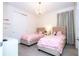 Bright ' bedroom with two twin beds, closet and overhead chandelier at 7600 Mackinaw Ln, Kissimmee, FL 34747