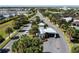 Aerial view of a gated community entrance with palm trees and well-manicured landscaping in a suburban neighborhood at 7600 Mackinaw Ln, Kissimmee, FL 34747