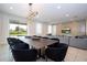 Open-concept dining room with a large table and view of the outdoor space at 7600 Mackinaw Ln, Kissimmee, FL 34747