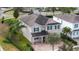Well-maintained two-story home with a manicured lawn and lush landscaping on a corner lot at 7600 Mackinaw Ln, Kissimmee, FL 34747