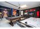 Entertaining game room with pool table, air hockey, and sports decor at 7600 Mackinaw Ln, Kissimmee, FL 34747
