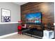 Modern home theater featuring a mounted TV and home entertainment center with popcorn machine at 7600 Mackinaw Ln, Kissimmee, FL 34747