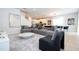 Inviting living room with a sectional sofa, plush rug, and modern decor at 7600 Mackinaw Ln, Kissimmee, FL 34747