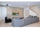 Comfortable living room features a sectional sofa, concrete accent wall, and mounted TV at 7600 Mackinaw Ln, Kissimmee, FL 34747