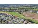 Aerial view of homes in a neighborhood next to a golf course at 1012 Everest St, Clermont, FL 34711