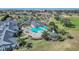 Birds-eye view of clubhouse with pool, covered seating, and manicured greenery at 1012 Everest St, Clermont, FL 34711