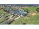 Aerial view of clubhouse, featuring a pool, scenic landscaping, and convenient parking at 1012 Everest St, Clermont, FL 34711