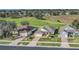 Aerial view of a home with a well-maintained lawn next to a lush golf course at 1012 Everest St, Clermont, FL 34711