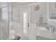 Clean and modern bathroom with a walk-in shower, white vanity, and marble accents, exuding minimalist elegance at 1012 Everest St, Clermont, FL 34711