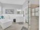 Serene bathroom featuring a soaking tub, a separate glass-enclosed shower, and white cabinetry for a clean, modern look at 1012 Everest St, Clermont, FL 34711