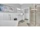 Elegant bathroom boasting a soaking tub, frameless shower, and marble countertops, creating a luxurious retreat at 1012 Everest St, Clermont, FL 34711