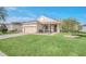 Charming home featuring a well-manicured lawn, inviting front porch, and a two-car garage at 1012 Everest St, Clermont, FL 34711