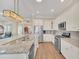 Kitchen with stainless steel appliances, granite countertops, and a large island at 1012 Everest St, Clermont, FL 34711