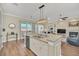 Spacious kitchen with a granite island that is open to the living room and an eating nook at 1012 Everest St, Clermont, FL 34711