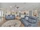 Open-concept living room with hardwood floors, ceiling fan, and modern furniture at 1012 Everest St, Clermont, FL 34711