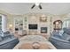 Stylish living room with a fireplace, built-in shelving, and open access to other living areas at 1012 Everest St, Clermont, FL 34711