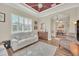 Inviting living room with a red accent ceiling, natural light, and open access to the dining area at 1012 Everest St, Clermont, FL 34711