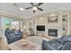 Cozy living room with a fireplace, sliding doors to outdoor patio, and ample natural light at 1012 Everest St, Clermont, FL 34711