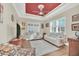 Bright living room with large windows, plantation shutters, and a cozy seating arrangement at 1012 Everest St, Clermont, FL 34711