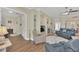 Bright living room featuring wood floors and access to the kitchen area and front entrance at 1012 Everest St, Clermont, FL 34711
