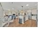 Open-concept living space with fireplace, kitchen, and eat-in nook with hardwood floors at 1012 Everest St, Clermont, FL 34711