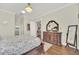 A main bedroom featuring wood flooring, an ornate dresser with a mirror, and a view into other rooms at 1012 Everest St, Clermont, FL 34711