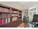 Office features custom wood cabinetry, built-in bookcases, hardwood floors, and natural light at 1012 Everest St, Clermont, FL 34711