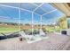 Screened patio with lounge seating and a clear view of the community golf course at 1012 Everest St, Clermont, FL 34711