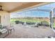 Screened patio offering outdoor dining, lounge seating, and scenic golf course views at 1012 Everest St, Clermont, FL 34711