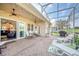 Outdoor patio featuring a grill, dining set, lounge chairs, and sliding door entrance at 1012 Everest St, Clermont, FL 34711