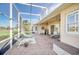 Screened patio with dining and lounge areas, perfect for enjoying the outdoors at 1012 Everest St, Clermont, FL 34711