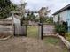 Private backyard access through a gate with wooden fence at 124 Hollyhock Ct, Kissimmee, FL 34743
