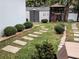 Landscaped backyard with stone path, shed, and greenery at 124 Hollyhock Ct, Kissimmee, FL 34743