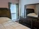 Bedroom with dresser and full-size bed at 124 Hollyhock Ct, Kissimmee, FL 34743