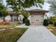 Two-car garage with light taupe doors and a stone facade at 124 Hollyhock Ct, Kissimmee, FL 34743