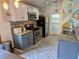 Modern kitchen with gray cabinets, granite counters, and herringbone floors at 124 Hollyhock Ct, Kissimmee, FL 34743