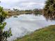 Scenic lake view with reflections of homes and trees at 124 Hollyhock Ct, Kissimmee, FL 34743