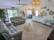 Open concept living area with gray sofas and kitchen views at 124 Hollyhock Ct, Kissimmee, FL 34743