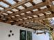 Wooden pergola with translucent roofing and string lights at 124 Hollyhock Ct, Kissimmee, FL 34743