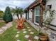 Landscaped side yard with stone pathway and rocking chairs at 124 Hollyhock Ct, Kissimmee, FL 34743