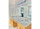 Double vanity bathroom with granite countertops and large mirror at 124 Lancaster Dr, Davenport, FL 33897