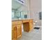 Double vanity bathroom with wood cabinets and granite countertops at 124 Lancaster Dr, Davenport, FL 33897