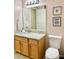 Bathroom with granite countertop and wood cabinets at 124 Lancaster Dr, Davenport, FL 33897