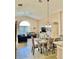 Bright dining room with patterned chairs and open concept view of living room at 124 Lancaster Dr, Davenport, FL 33897