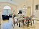 Bright dining room with patterned chairs and open concept view of living room at 124 Lancaster Dr, Davenport, FL 33897