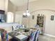 Dining area with a modern table and colorful chairs, adjacent to the kitchen at 124 Lancaster Dr, Davenport, FL 33897