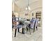 Dining area with a modern table and colorful chairs, adjacent to the kitchen at 124 Lancaster Dr, Davenport, FL 33897