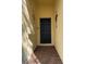 Front entry with a black door and brick flooring at 124 Lancaster Dr, Davenport, FL 33897